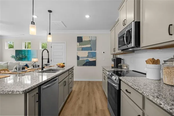 a kitchen with stainless steel appliances granite countertop a sink stove and refrigerator