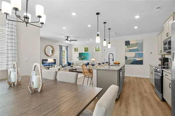 a large kitchen with a table and chairs