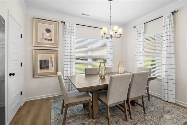 a view of a dining room with furniture window and wooden floor