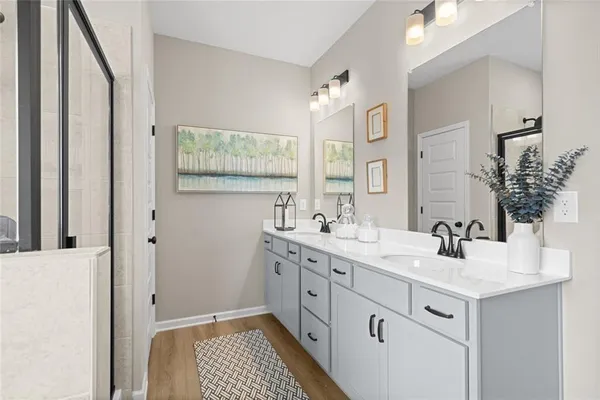 a bathroom with a double vanity sink mirror and