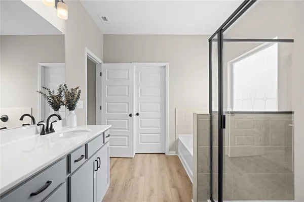 a bathroom with a double vanity sink a mirror and a shower