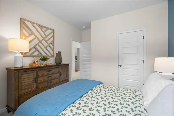 a bedroom with a bed and a dresser in it