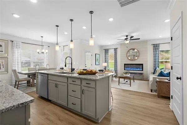 a kitchen with stainless steel appliances granite countertop stove top oven and cabinets