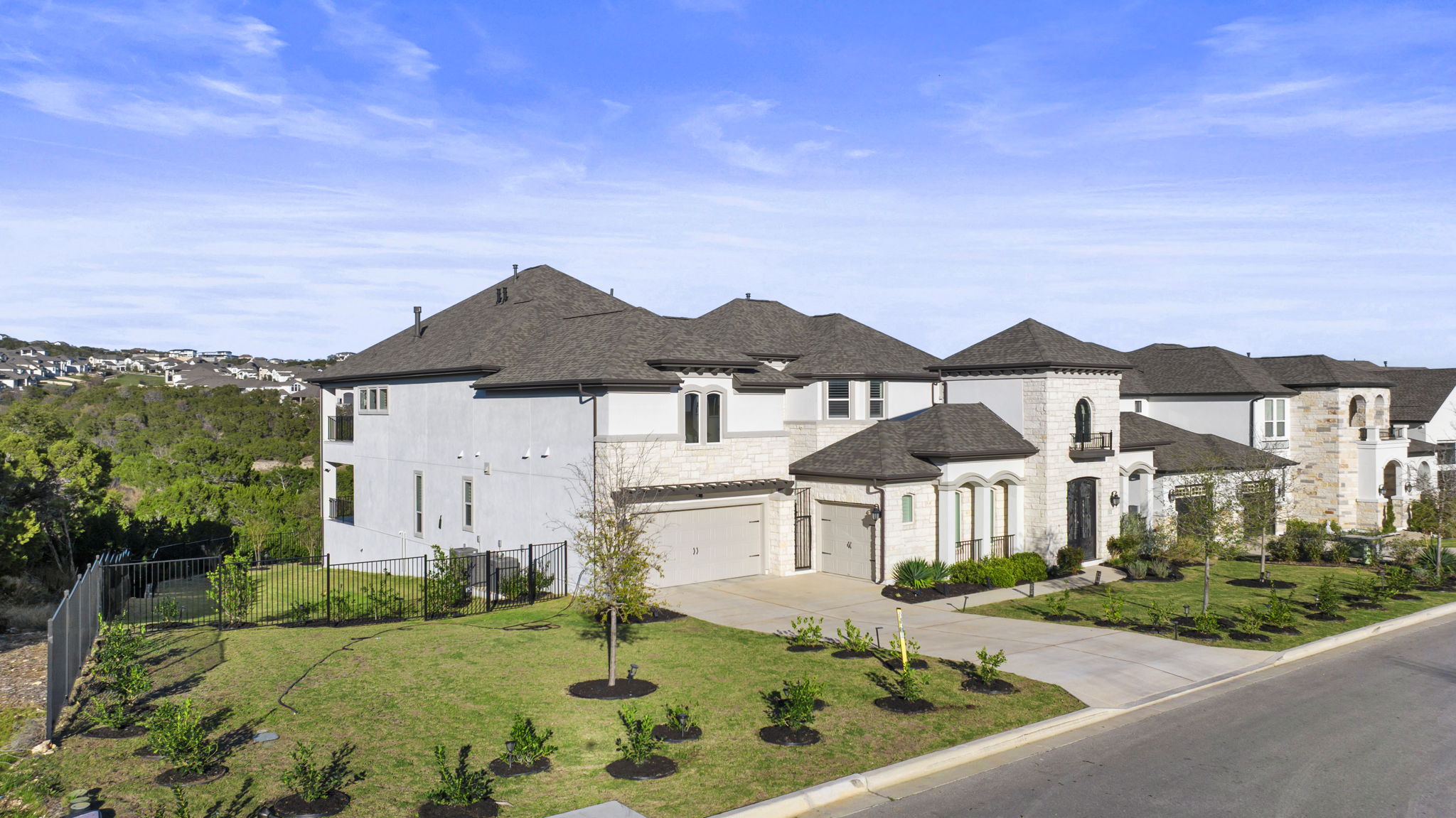 2132 Novara Trail Leander, TX 78641 - Photo 4 of 40 French country inspired facade with concrete driveway and a garage
