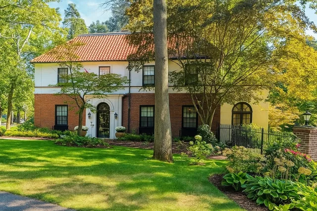 a front view of a house with garden