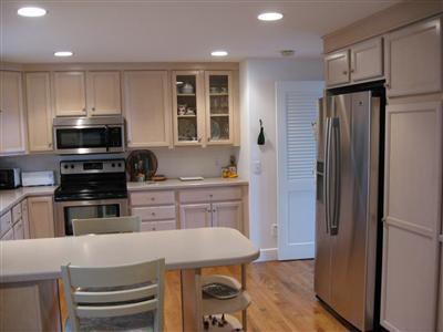 111 Goose Point Road Centerville, MA 02601 - Photo 7 of 21 a kitchen with kitchen island a sink stainless steel appliances and cabinets
