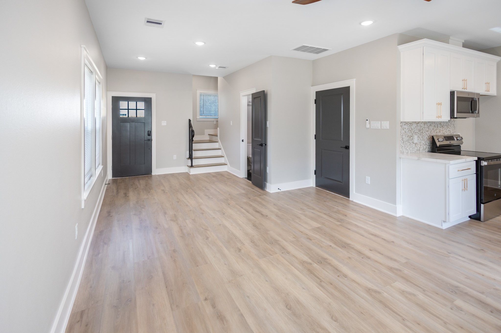 5036 Mallow Street, Unit A Houston, TX 77033 - Photo 11 of 36 a view of a kitchen with wooden floor and windows