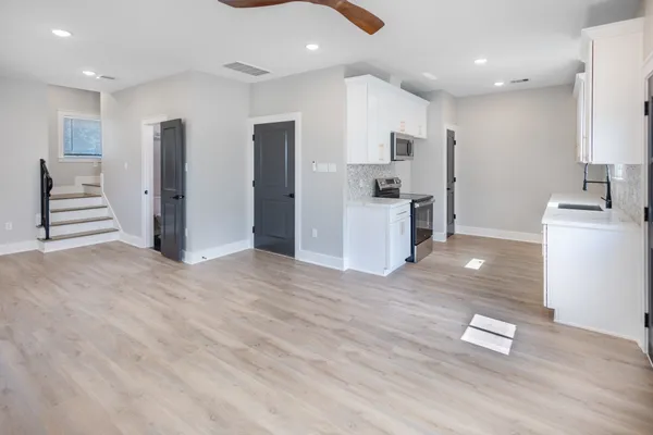 a kitchen with stainless steel appliances granite countertop a refrigerator and a stove top oven