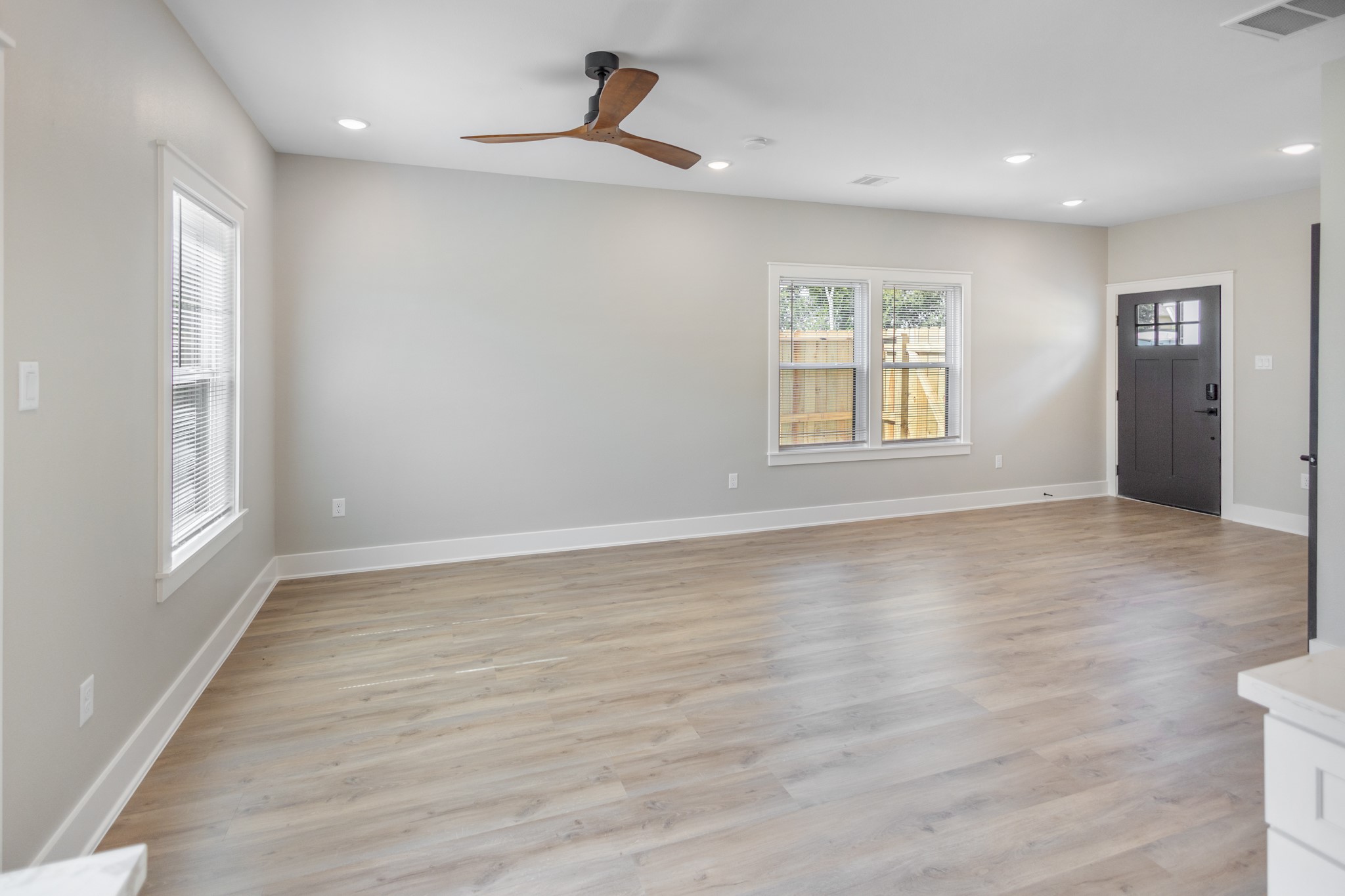 5036 Mallow Street, Unit A Houston, TX 77033 - Photo 14 of 36 an empty room with wooden floor and windows