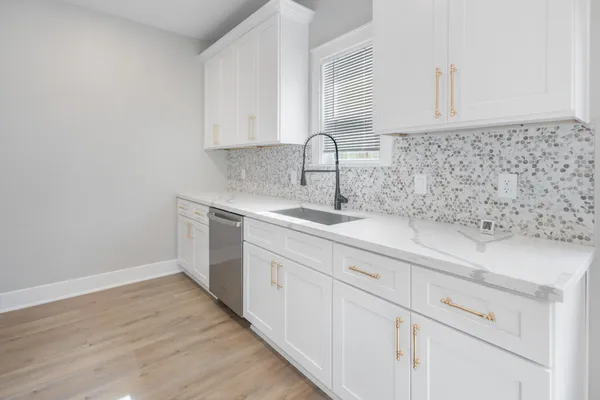 a kitchen with a sink and cabinets