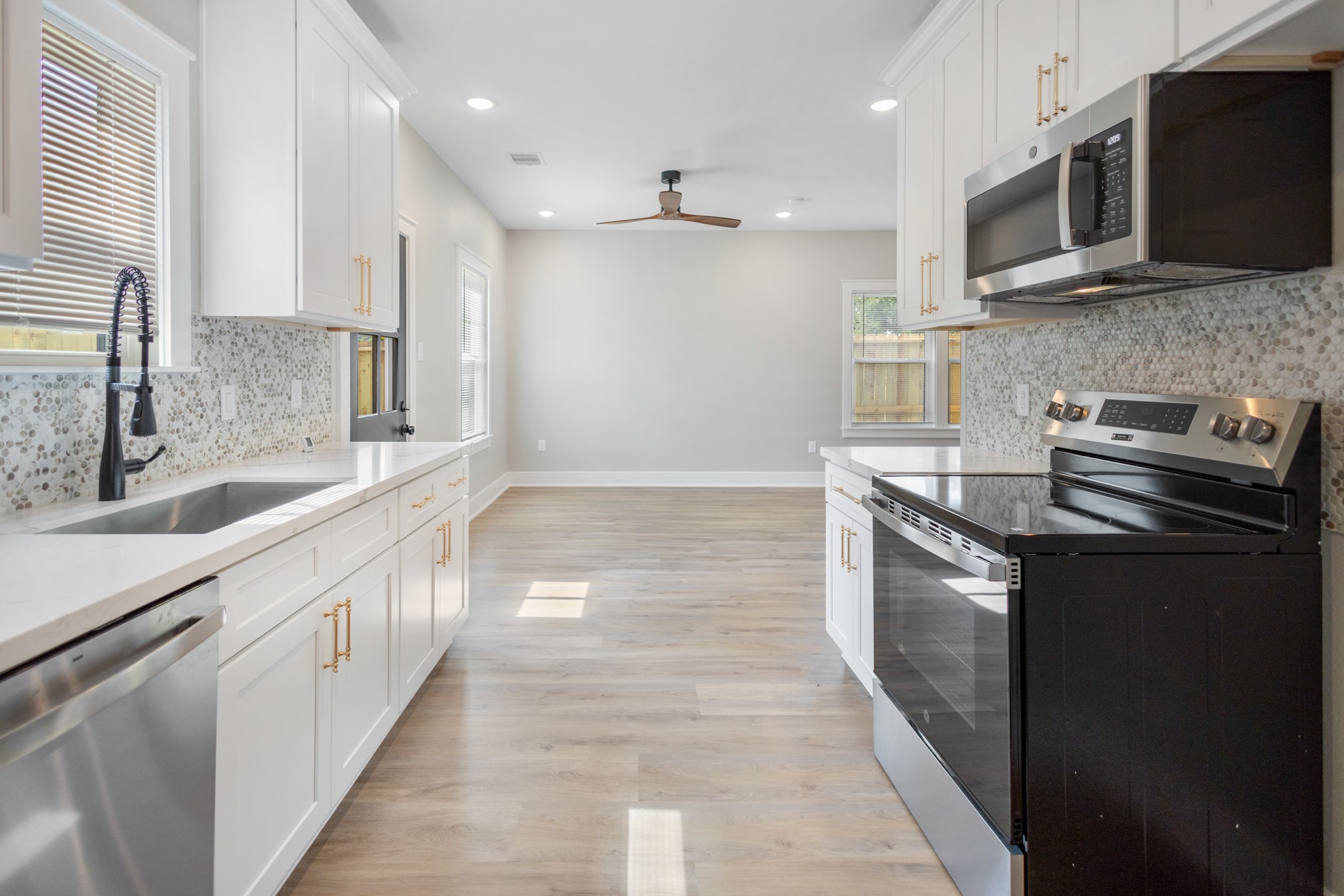 5036 Mallow Street, Unit A Houston, TX 77033 - Photo 18 of 36 a large kitchen with stainless steel appliances kitchen island granite countertop a sink and a stove
