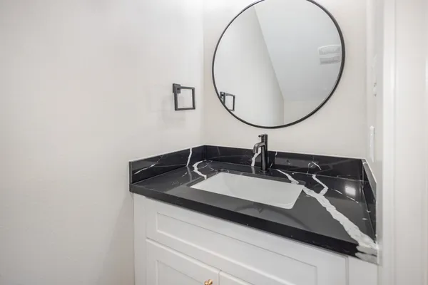 a bathroom with a sink and a mirror