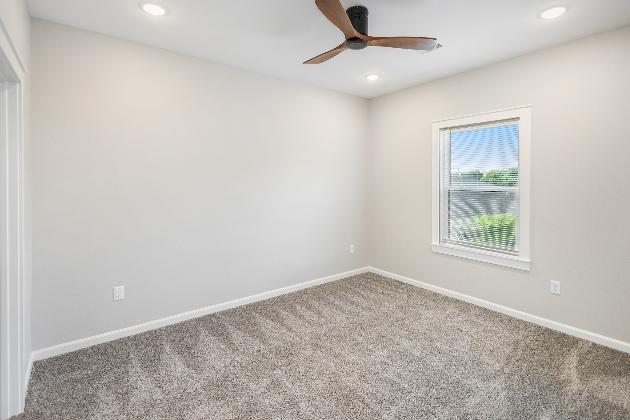 5036 Mallow Street, Unit A Houston, TX 77033 - Photo 23 of 36 an empty room with a window and a fan