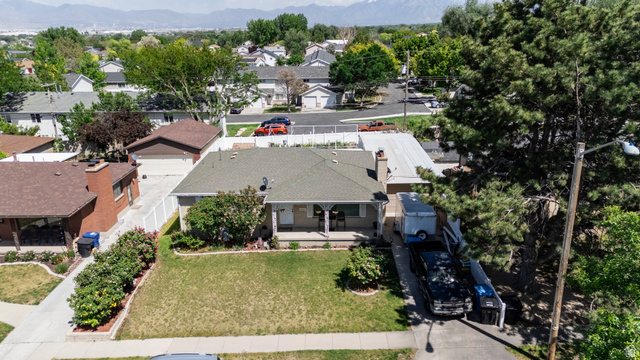 3233 Jean Street Magna, UT 84044 - Photo 32 of 33 Single-story residence featuring a covered front porch with columns, a verdant front lawn, and a paved driveway