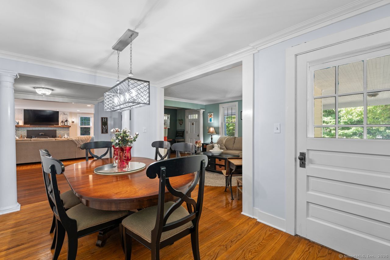 74 Middle Quarter Road Woodbury, CT 06798 - Photo 16 of 38 a view of a dining room with furniture a chandelier and wooden floor