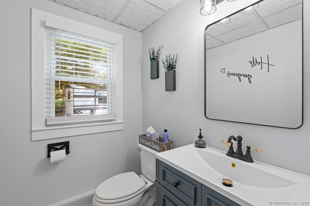 74 Middle Quarter Road Woodbury, CT 06798 - Photo 19 of 38 a bathroom with a sink vanity mirror and toilet