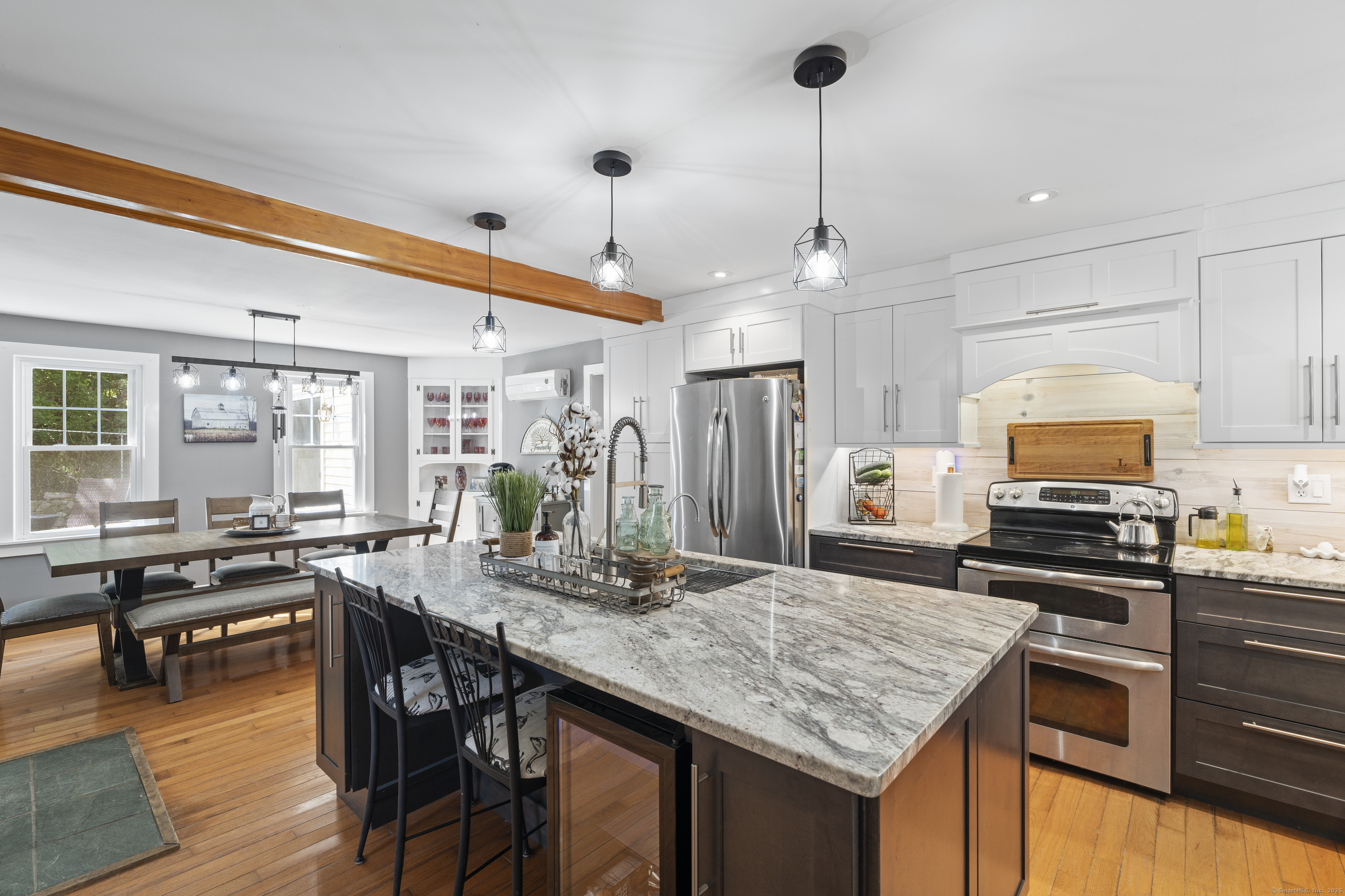 74 Middle Quarter Road Woodbury, CT 06798 - Photo 26 of 38 a kitchen with stainless steel appliances granite countertop a stove a sink dishwasher a dining table and chairs with wooden floor