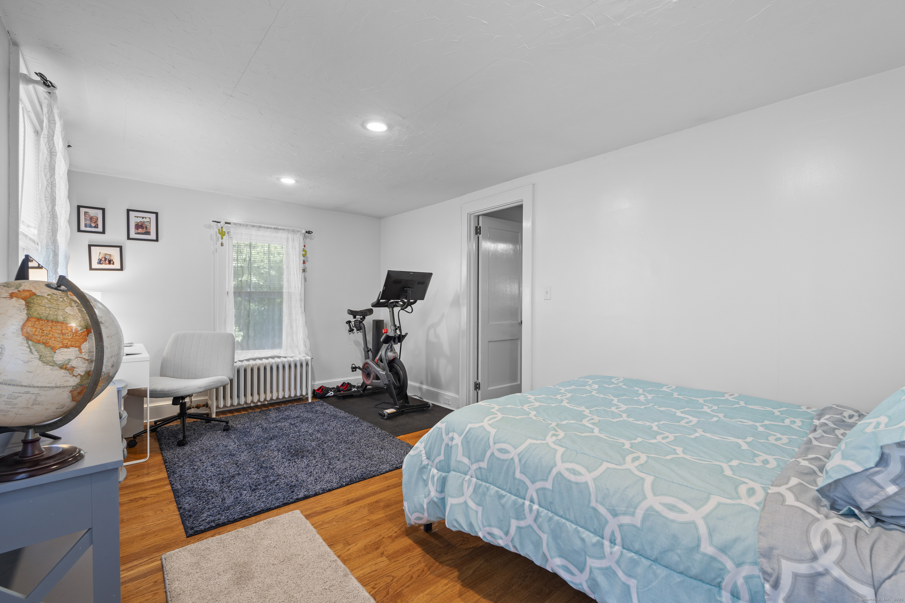 74 Middle Quarter Road Woodbury, CT 06798 - Photo 31 of 38 a bedroom with a bed and wooden floor