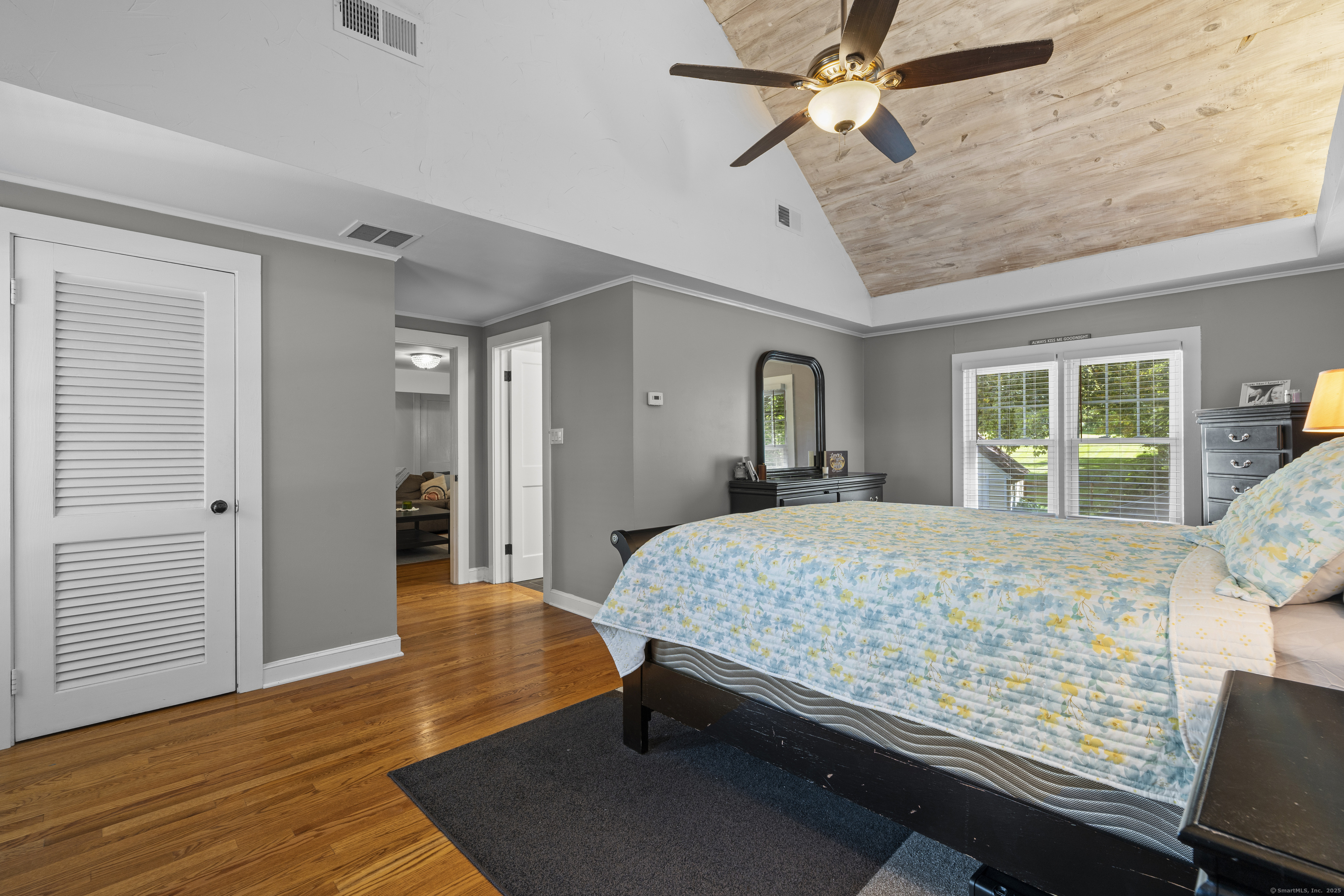 74 Middle Quarter Road Woodbury, CT 06798 - Photo 33 of 38 a bedroom with a large bed and a chandelier