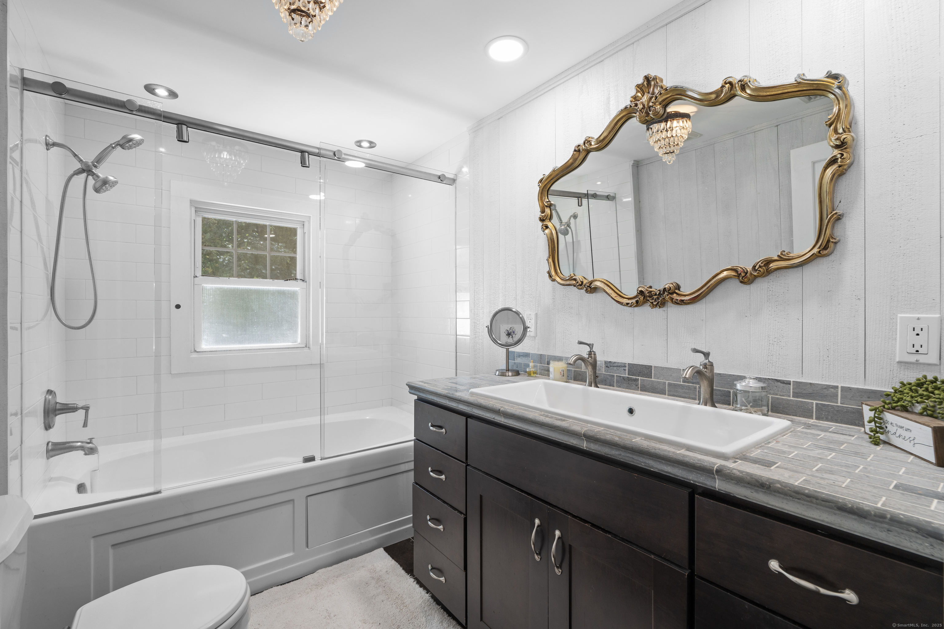 74 Middle Quarter Road Woodbury, CT 06798 - Photo 35 of 38 a bathroom with a granite countertop sink mirror vanity and toilet