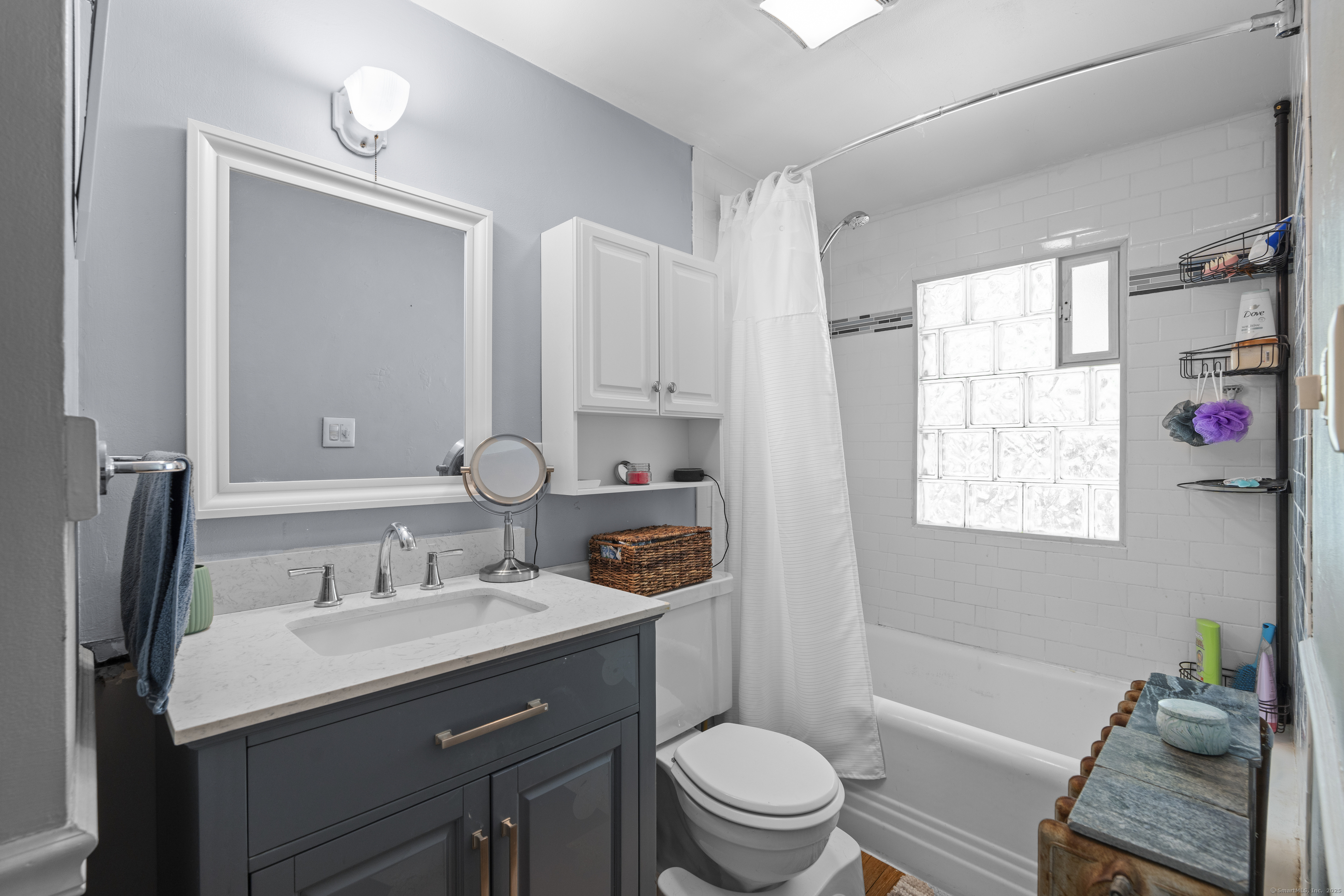 74 Middle Quarter Road Woodbury, CT 06798 - Photo 38 of 38 a bathroom with a granite countertop sink toilet a mirror and shower