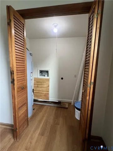 a view of a room with wooden floor and windows