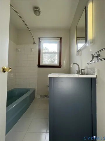 a bathroom with a sink a mirror and a bathtub