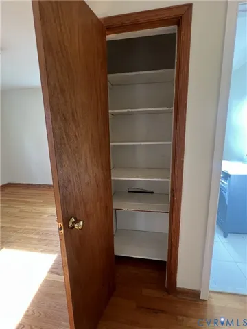 a view of walk in closet with empty racks