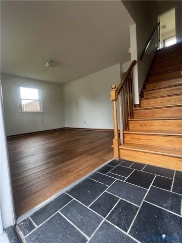 a view of a room with wooden floor and white walls