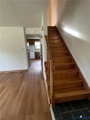 a view of entryway and hall with wooden floor
