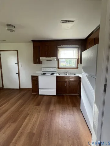 a kitchen with a refrigerator and a sink
