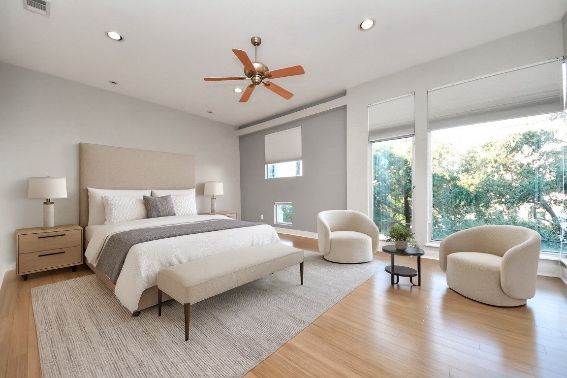 1610 Calumet Street Houston, TX 77004 - Photo 13 of 26 Sun-drenched primary suite retreat with expansive windows, airy open layout, and a cozy lounge area—designed for comfort, calm, and everyday luxury.