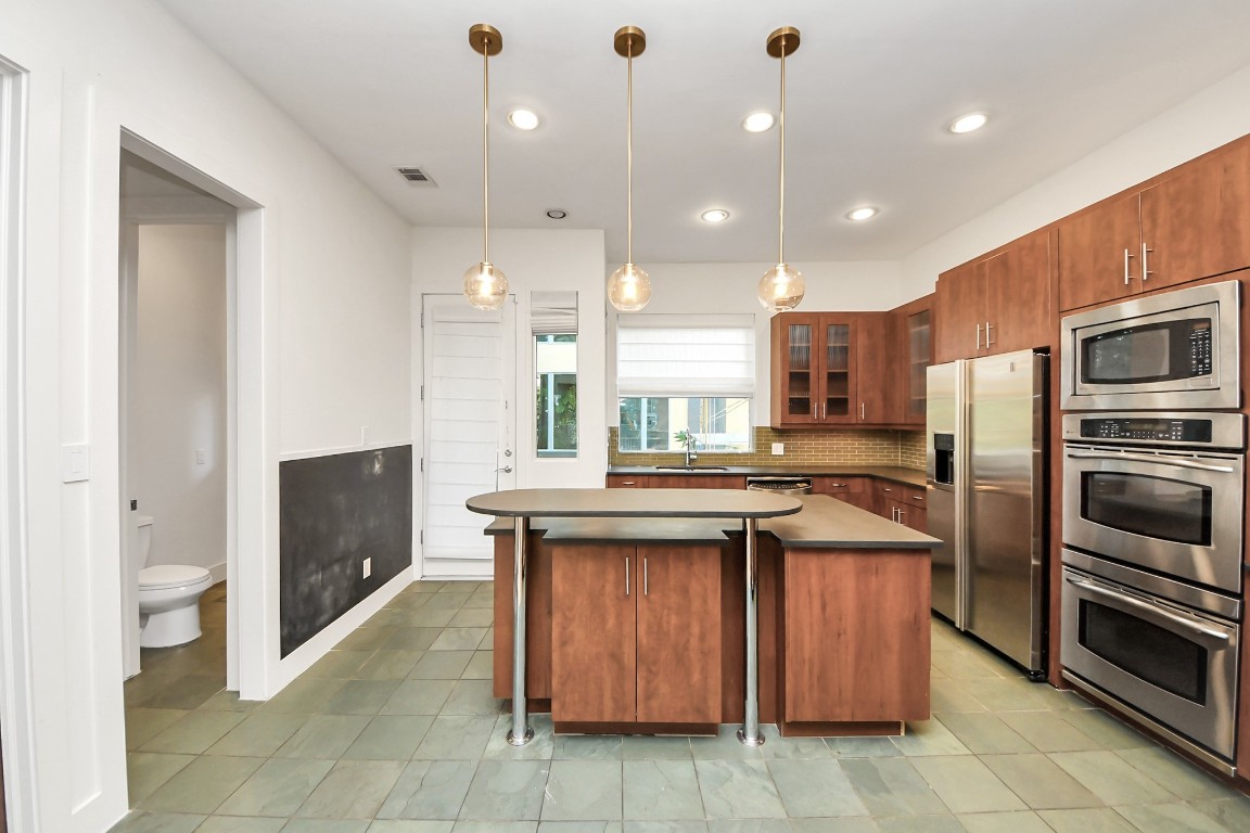 1610 Calumet Street Houston, TX 77004 - Photo 5 of 26 Kitchen with large island, raised breakfast bar, stainless steel appliances, soapstone countertops.