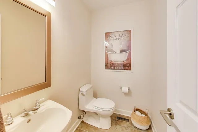 a white toilet sitting next to a bathroom sink