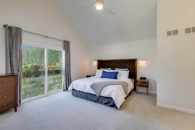 a bed sitting in a bedroom next to a window