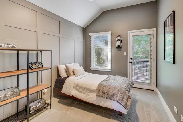 a bedroom with a bed next to a window