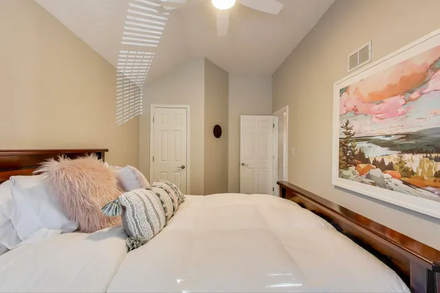 a bedroom with a bed and a large window