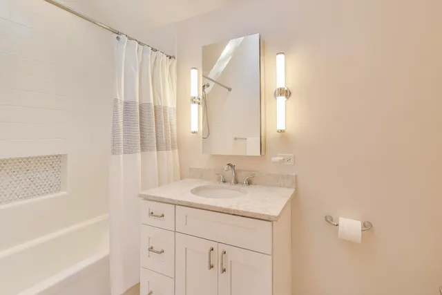 a bathroom with a sink a vanity and a mirror