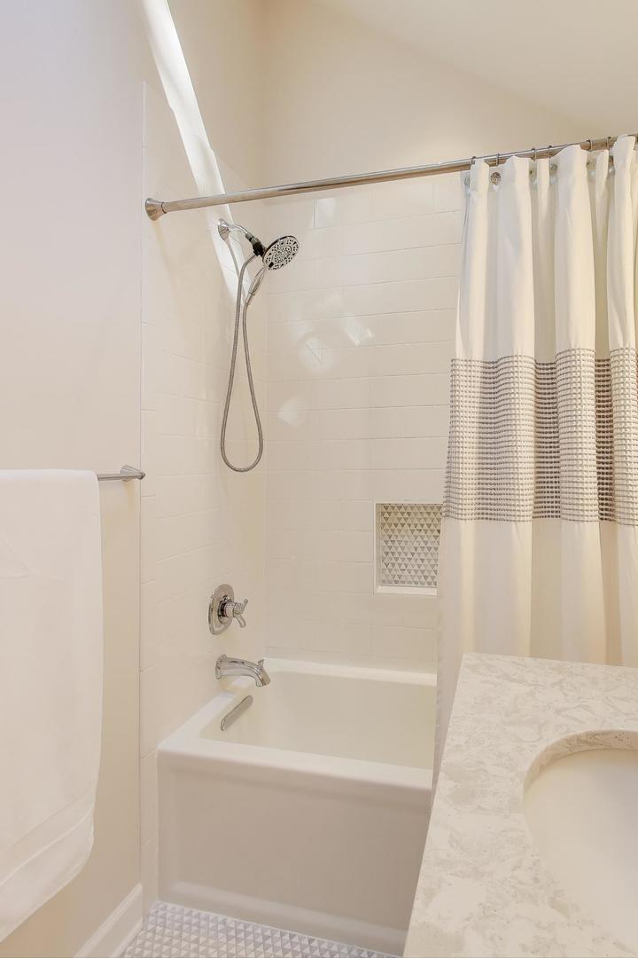 1614 West Erie Street Chicago, IL 60622 - Photo 24 of 50 a bathroom with a shower curtain and a bathtub