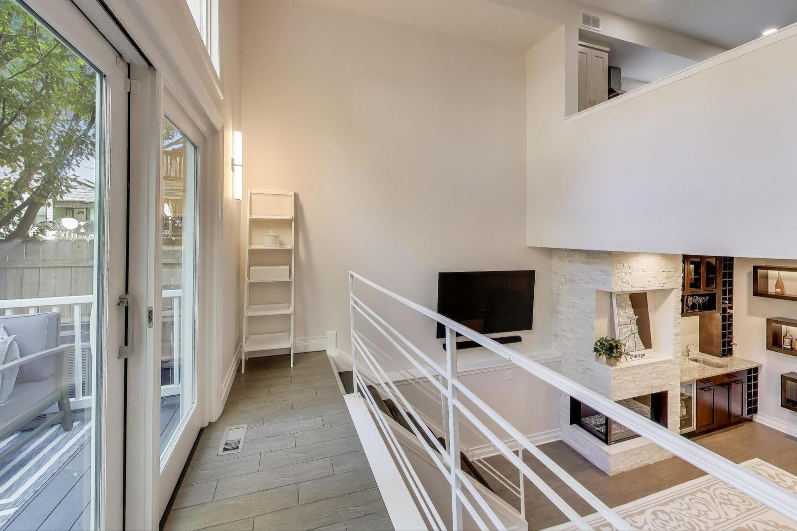 1614 West Erie Street Chicago, IL 60622 - Photo 25 of 50 a view of a living room and a flat screen tv