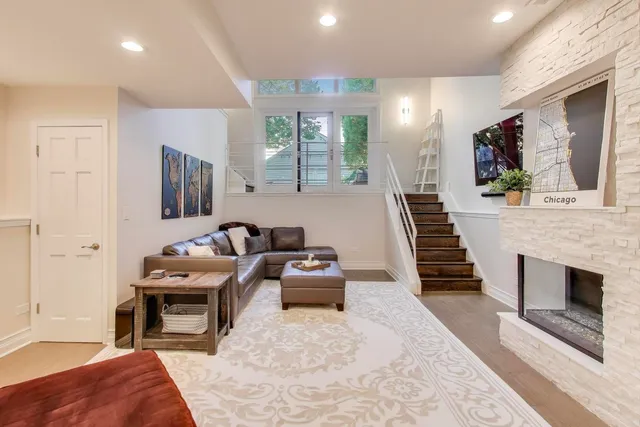 a living room with furniture a fireplace and a flat screen tv