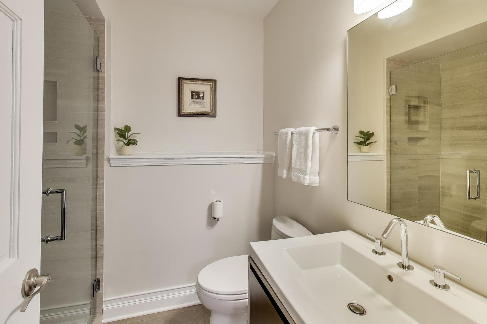 1614 West Erie Street Chicago, IL 60622 - Photo 35 of 50 a bathroom with a sink toilet and shower