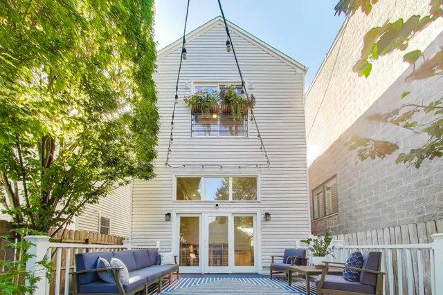 a view of a house with a chairs in patio