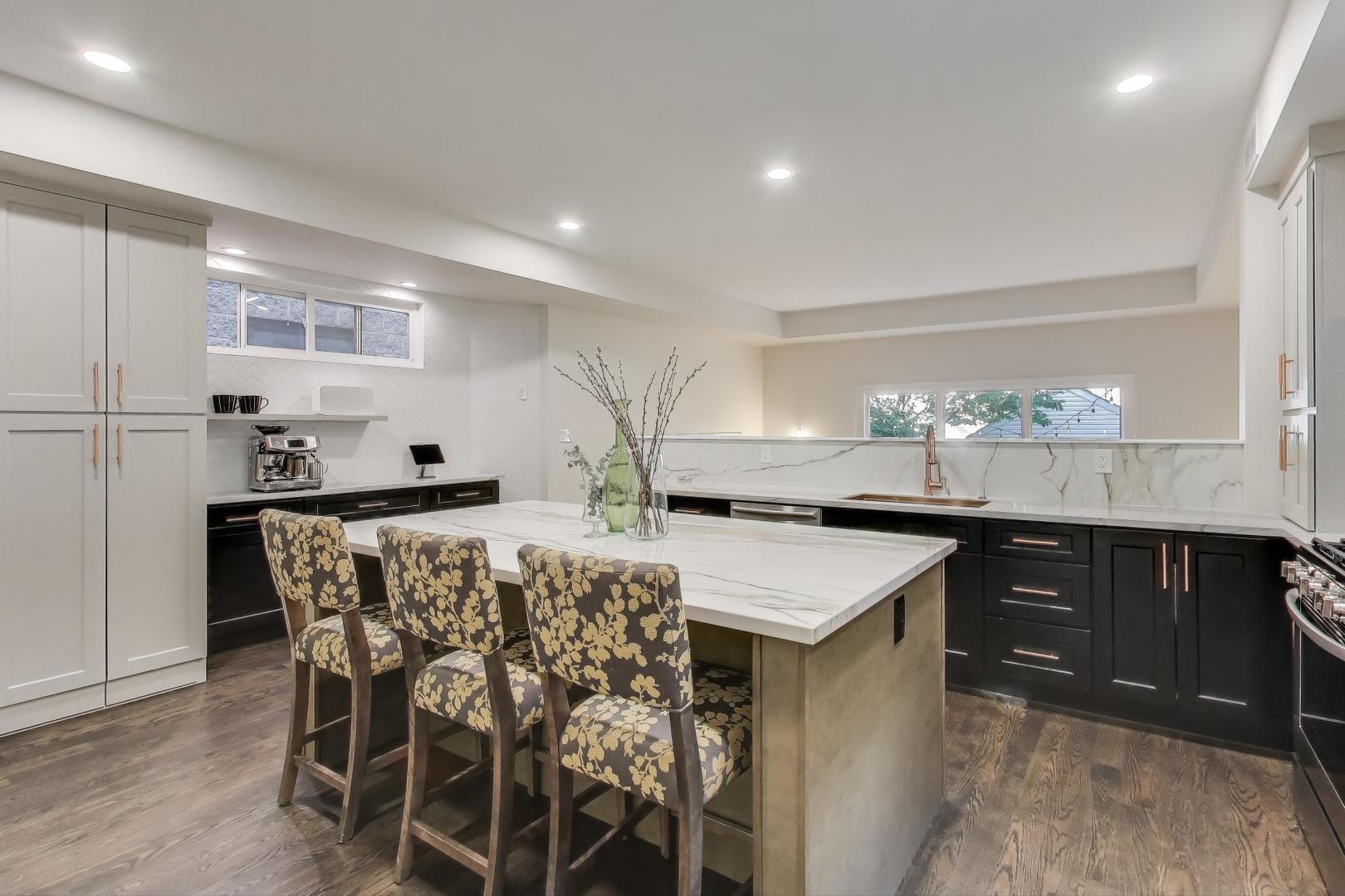 1614 West Erie Street Chicago, IL 60622 - Photo 9 of 50 a kitchen with kitchen island granite countertop a table and chairs in it