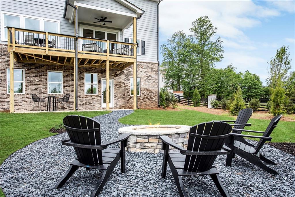 4765 Montane Street Cumming, GA 30028 - Photo 24 of 50 a view of a chairs and table in backyard of the house