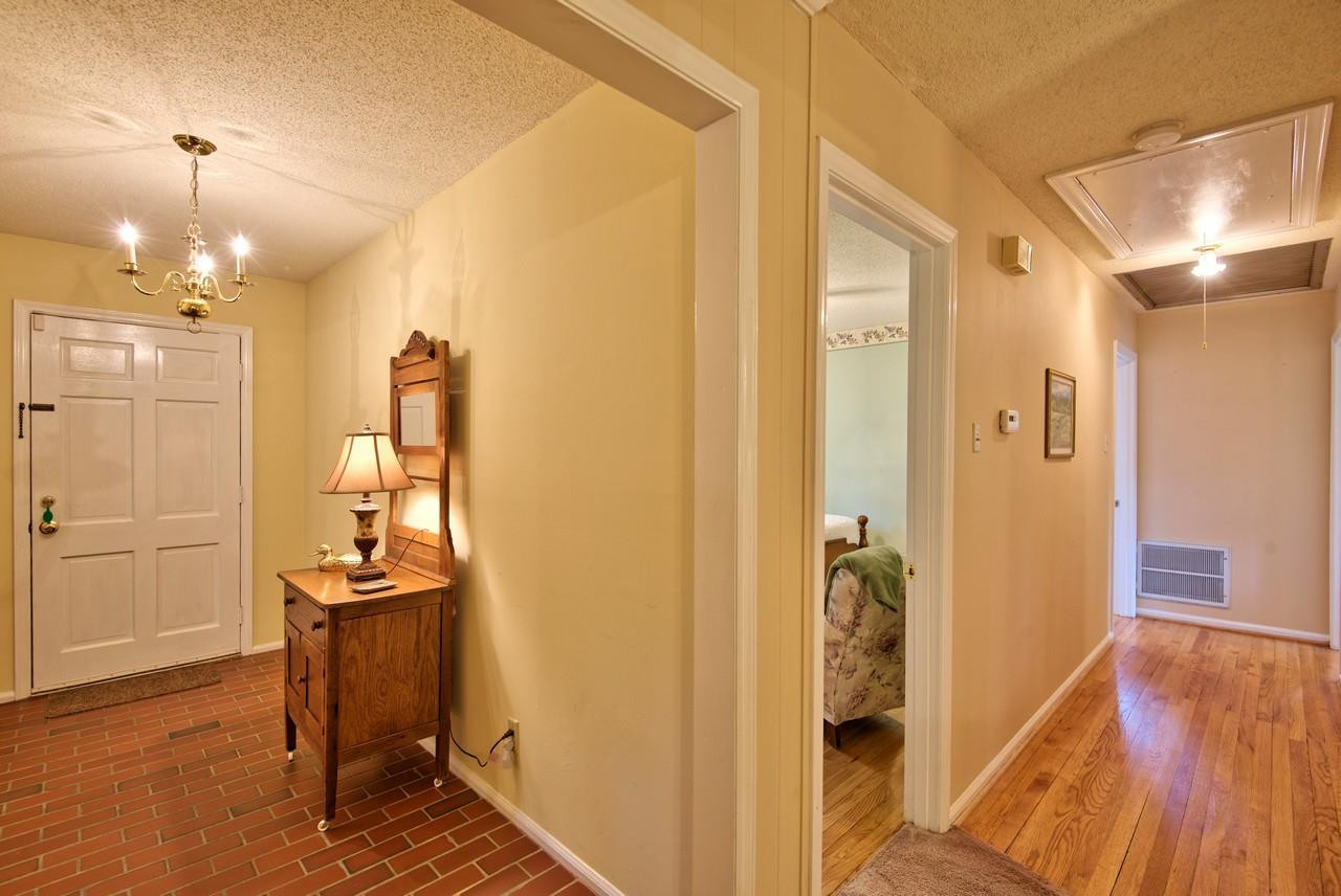 3607 Cole Mill Road Durham, NC 27712 - Photo 14 of 25 This is a picture of the Entry and Hallway. The pull down attic stairs are located in the hall. The attic is floored. Hall
