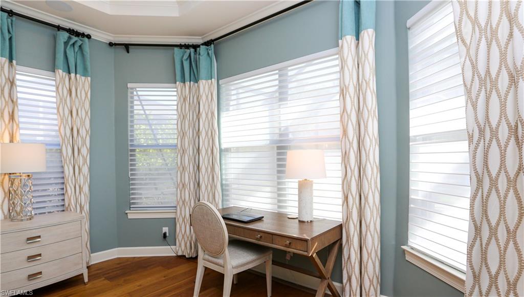 10155 Coconut Road Estero, FL 34135 - Photo 14 of 34 a dining room with furniture and wooden floor