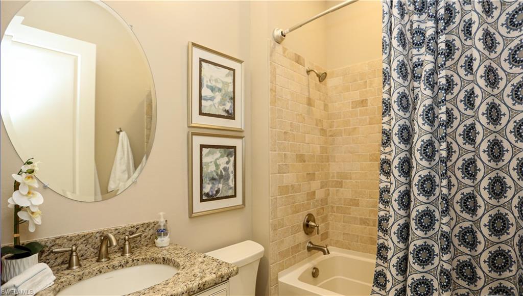 10155 Coconut Road Estero, FL 34135 - Photo 20 of 34 a bathroom with a sink toilet and shower