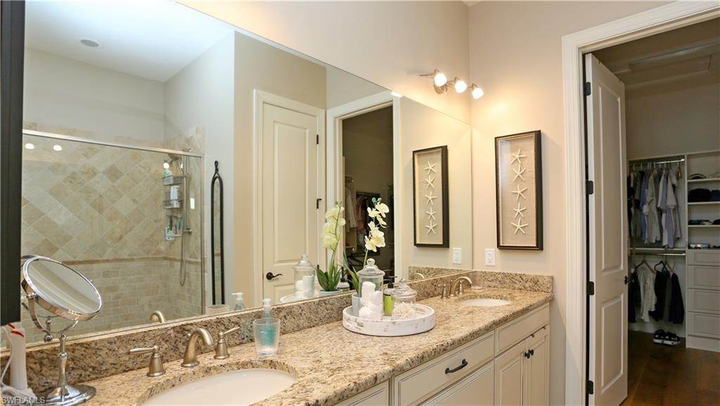 10155 Coconut Road Estero, FL 34135 - Photo 21 of 34 a bathroom with double vanity sinks and a mirror