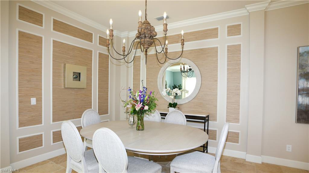 10155 Coconut Road Estero, FL 34135 - Photo 28 of 34 a dining room with furniture a potted plant and wooden floor